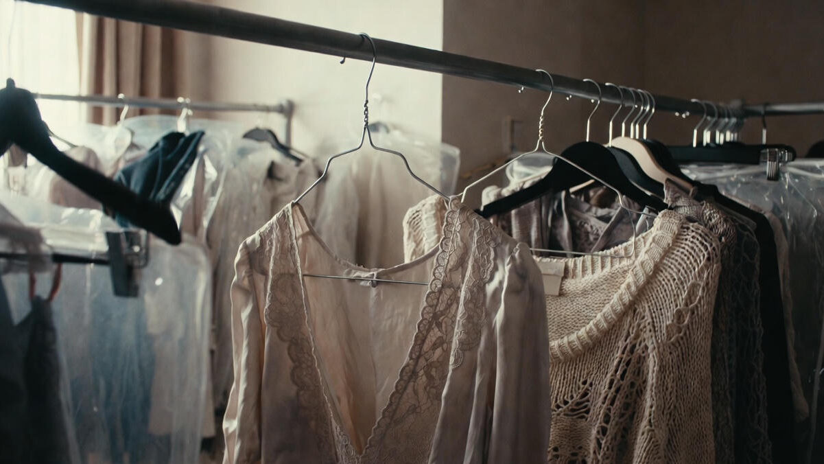 Incorrect storage of luxury clothes at home such as wire hangers and plastic covers showing common mistakes that make it harder to maintain luxury clothes